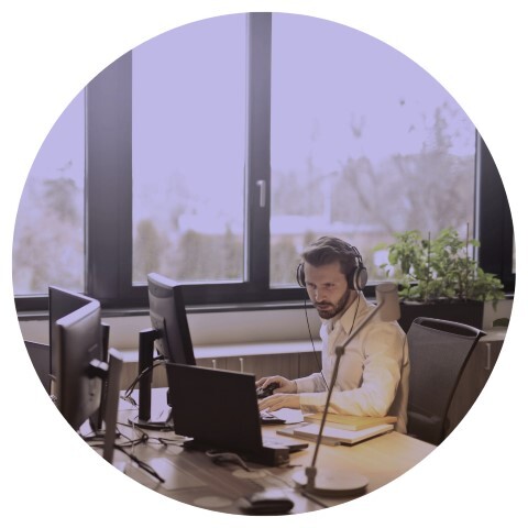 Man on computer wearing headset